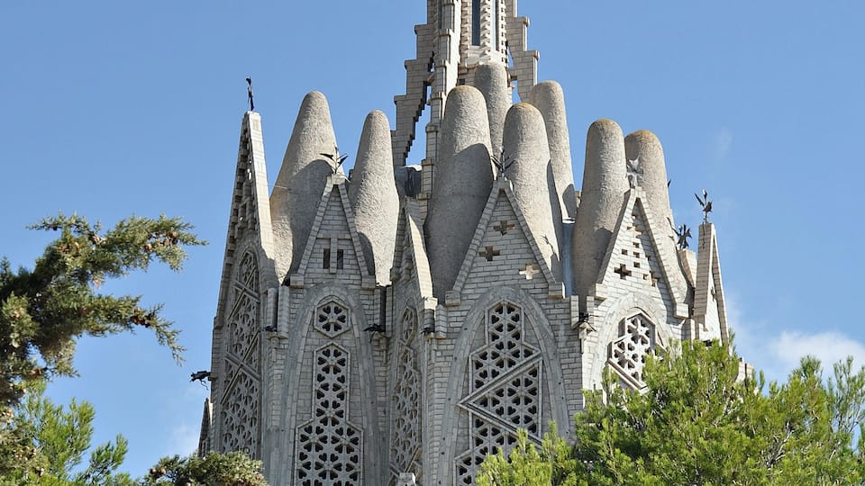 A Gothic-style church with a tall spire and intricate stonework.