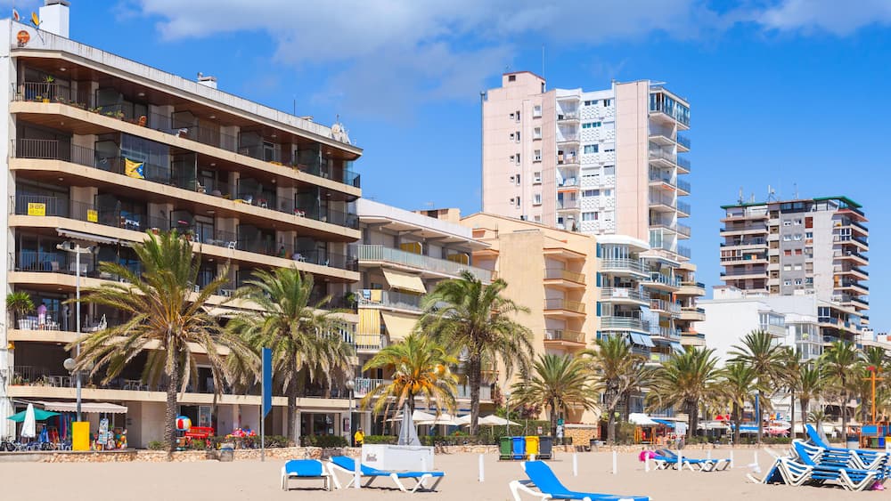 Public beach of Calafell resort town in a sunny summer day. Tarragona region, Catalonia, Spain