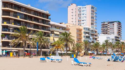 Public beach of Calafell resort town in a sunny summer day. Tarragona region, Catalonia, Spain