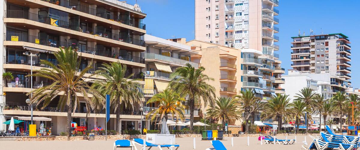 Public beach of Calafell resort town in a sunny summer day. Tarragona region, Catalonia, Spain