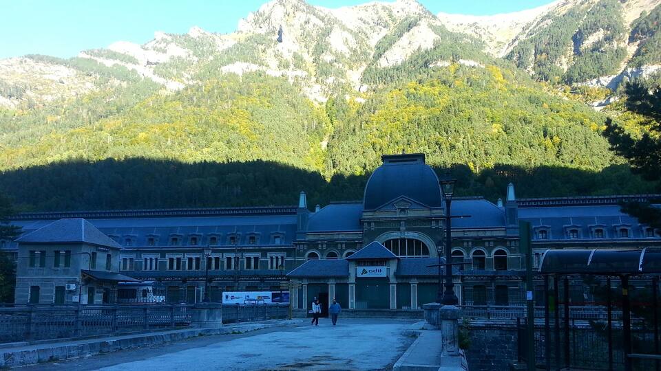 A historic building with a large dome, surrounded by a mountainous landscape.