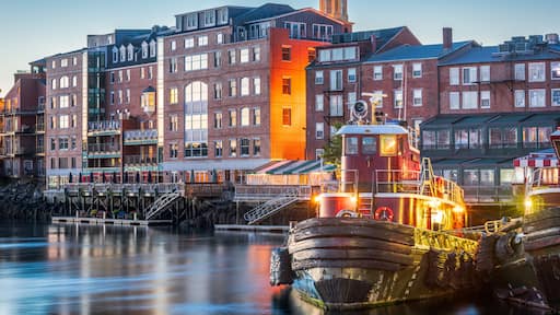 Portsmouth, New Hampshire, USA town cityscape with tugboats