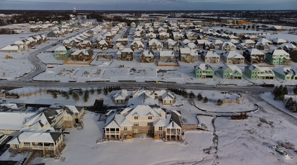 Snow covered new residential buildings plots in the area between Nicholasville and Lexington, Kentucky in different stages of the construction process