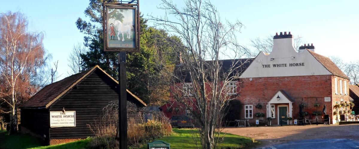 A pub named The White Horse with a signboard and a smaller building labeled as Garden - Function Room.