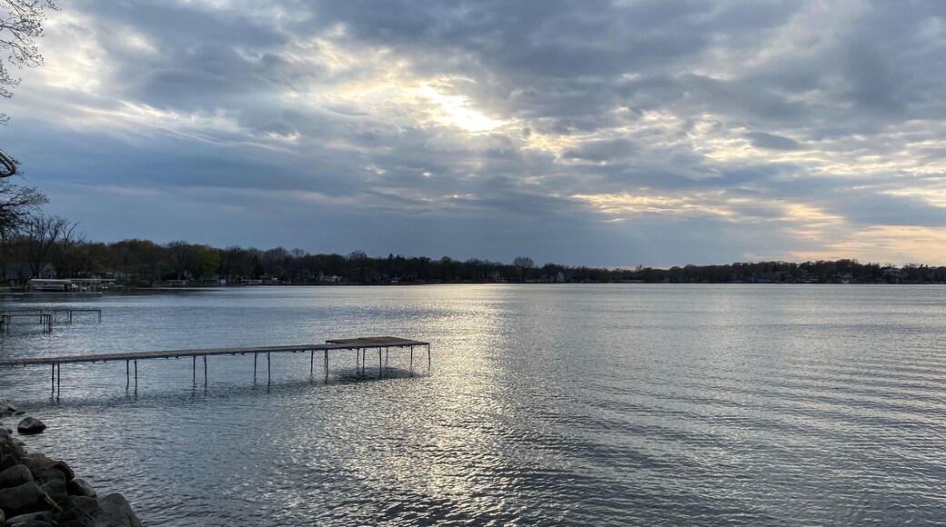 spring silver gray sunset over the lake with pier