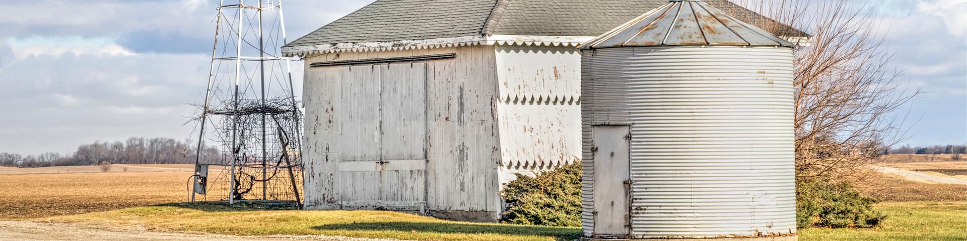 Little Barn, Bin, and Windmill Under a Blue Cloudy Midwestern Sky in Ohio