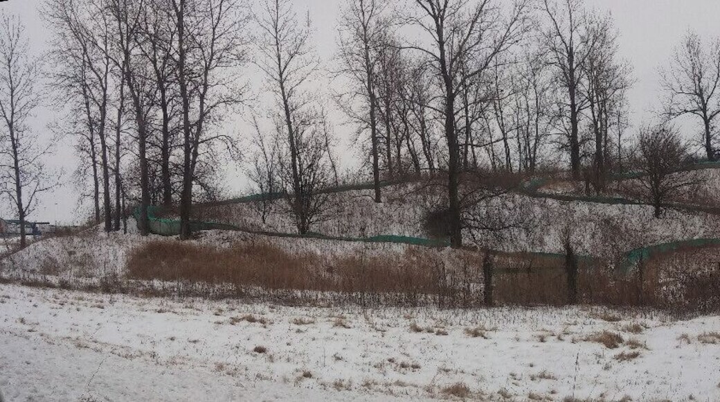 A snow covered abandoned water slide just seemingly plopped in the middle of a farm field along interstate 71. Maybe a one time campground or RV park?