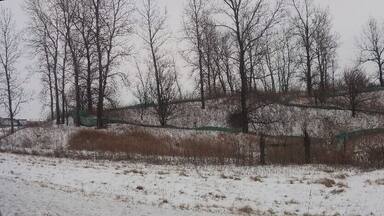 A snow covered abandoned water slide just seemingly plopped in the middle of a farm field along interstate 71. Maybe a one time campground or RV park?