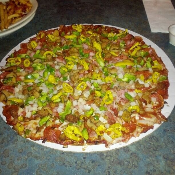 Kingy's award winning all the way pizza with cheese, pepperoni, sausage, mushrooms, onions, green pepper, ham and banana peppers.