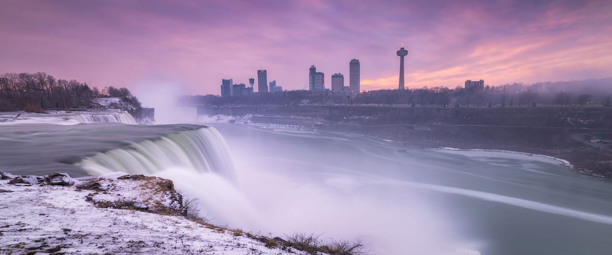 A waterfall, a city skyline, and a tower.
