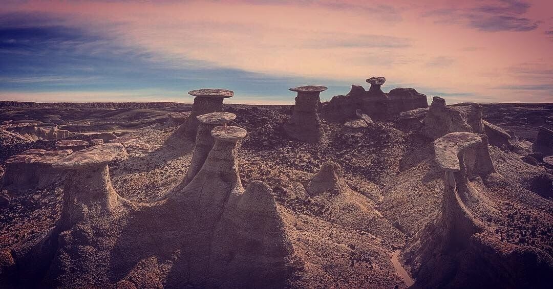 A landscape with unique rock formations and a clear sky.