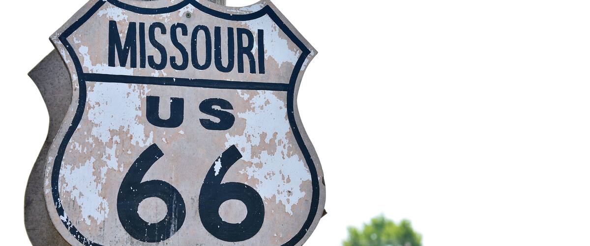 A weathered sign for Route 66 in Missouri.