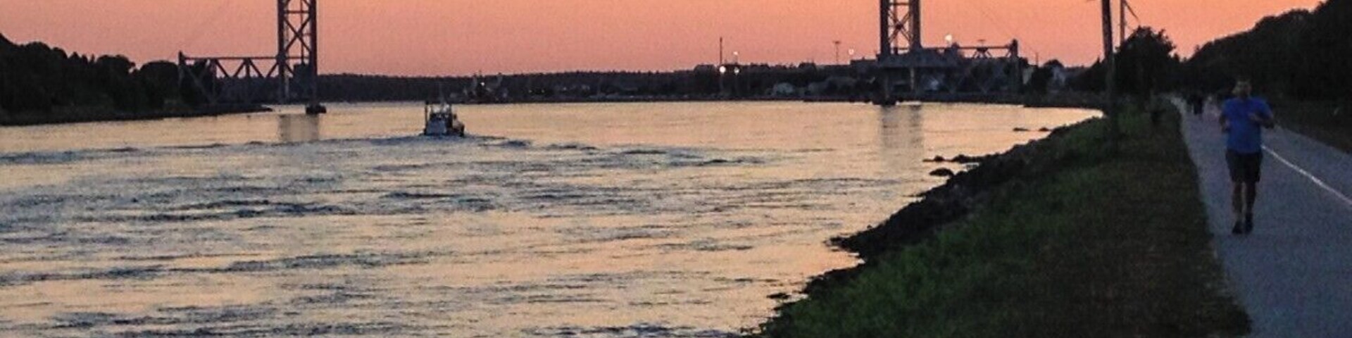 A bridge over a river at sunset.