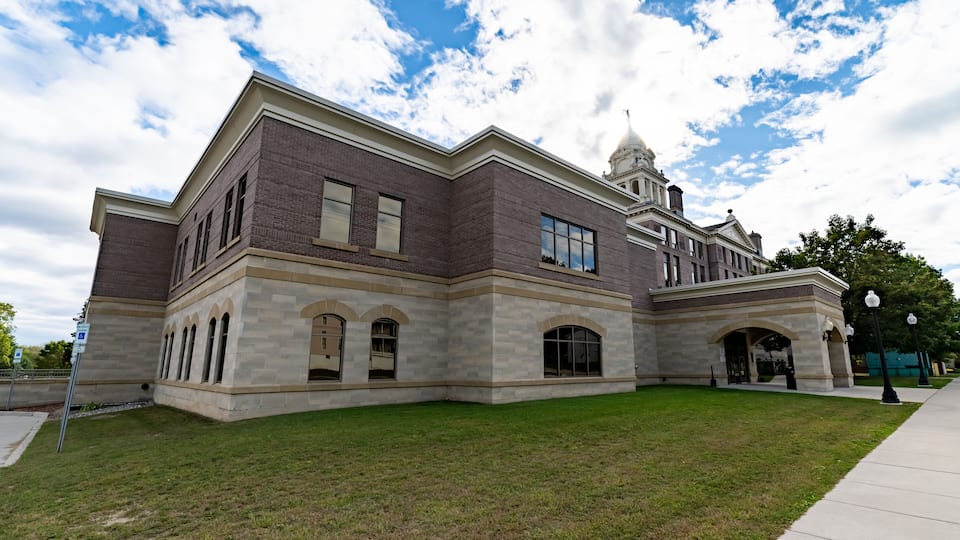 Wide Angle of Ionia County, MI Courthouse with Blue Sky and Green Grass