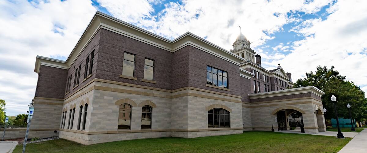 A large, historic building with a prominent dome and arched windows.