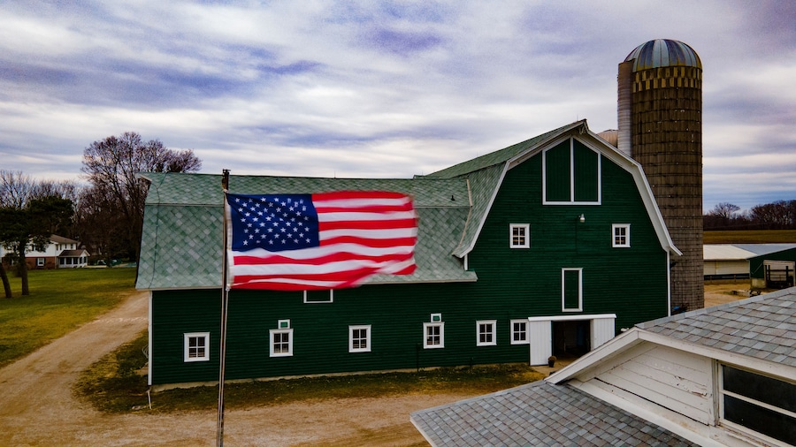 American flag and green barn in Coopersville, Michigan.