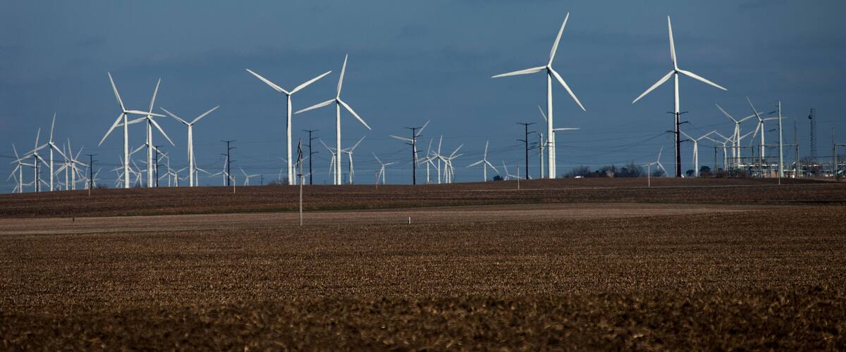 A wind farm with multiple wind turbines in a field.