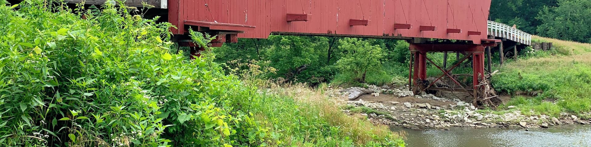 #adventure
Built in 1883 by Harvey P. Jones and George K. Foster, Roseman is 107 feet in length and sits in its original location. It was renovated in 1992 at a cost of $152,515. In Robert James Waller’s novel, The Bridges of Madison County, and the movie of the same name, Roseman is the bridge Robert Kincaid seeks when he stops at Francesca Johnson’s home for directions. It is also where Francesca leaves her note inviting him to dinner.
Also known as the “haunted” bridge, Roseman is where two sheriff’s posses trapped a county jail escapee in 1892. It is said the man rose up straight through the roof of the bridge, uttering a wild cry, and disappeared. He was never found, and it was decided that anyone capable of such a feat must be innocent.