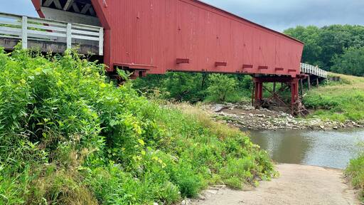 #adventure
Built in 1883 by Harvey P. Jones and George K. Foster, Roseman is 107 feet in length and sits in its original location. It was renovated in 1992 at a cost of $152,515. In Robert James Wallerโs novel, The Bridges of Madison County, and the movie of the same name, Roseman is the bridge Robert Kincaid seeks when he stops at Francesca Johnsonโs home for directions. It is also where Francesca leaves her note inviting him to dinner.
Also known as the โhauntedโ bridge, Roseman is where two sheriffโs posses trapped a county jail escapee in 1892. It is said the man rose up straight through the roof of the bridge, uttering a wild cry, and disappeared. He was never found, and it was decided that anyone capable of such a feat must be innocent.
