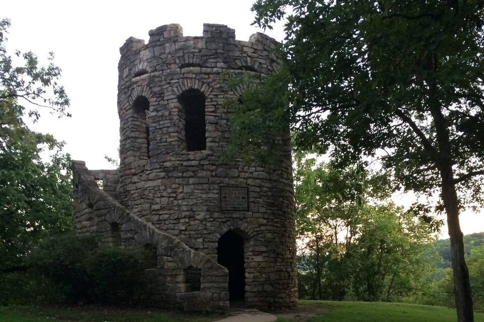 A stone tower with arched windows and a sign reading "Fletcher & Rouse Historic Site."