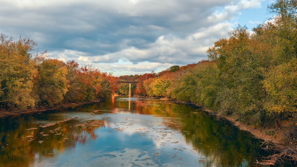 Monocacy River and a railway bridge on the background in autumn