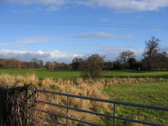 View across Lavister Brook and Darland Golf Course The view across Darland Golf Course from a field gate alongside Wrexham Road. The line of rough grass across the photo marks the line of Lavister Brook.