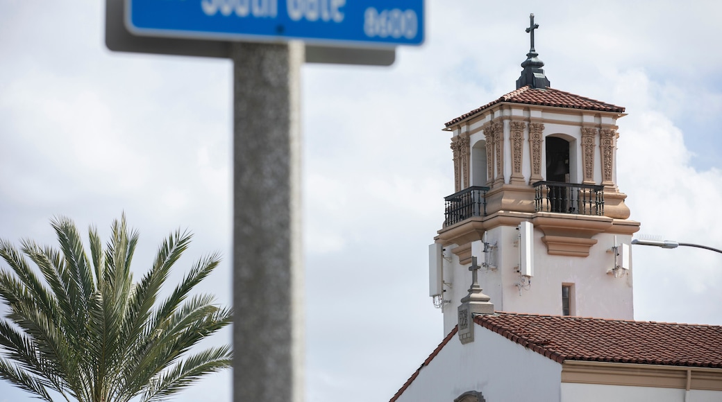 South Gate, California, USA - February 11, 2023: Sun shines on a historic church and street scene in South Gate.