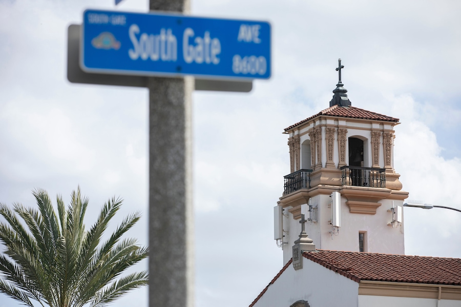 South Gate, California, USA - February 11, 2023: Sun shines on a historic church and street scene in South Gate.
