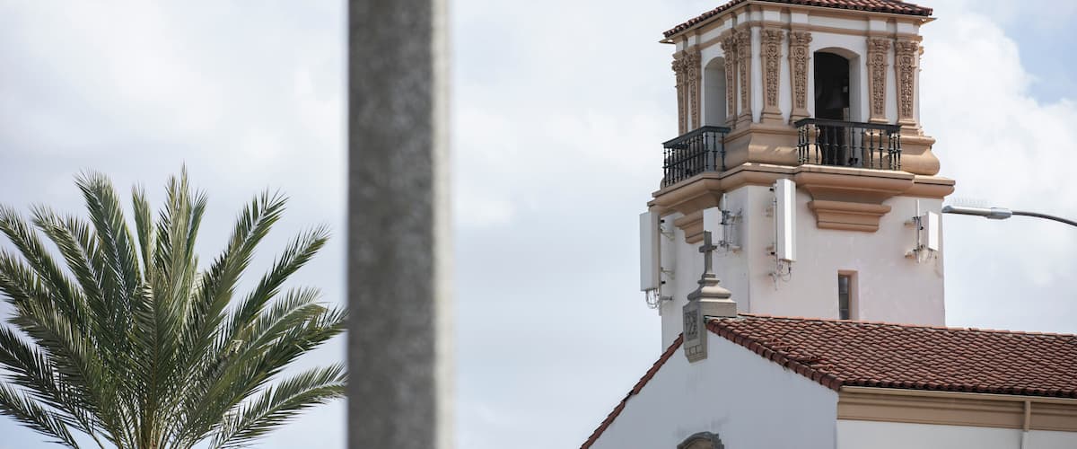 South Gate, California, USA - February 11, 2023: Sun shines on a historic church and street scene in South Gate.