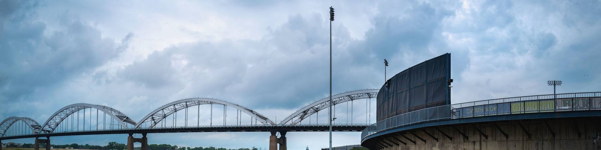 Panoramic landscaper of Centennial Bridge over the Mississippi River and the curved bike trails and footpaths, the view from LeClaire Park and Bandshell in Davenport, Iowa