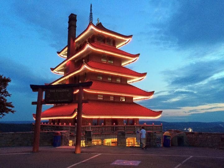 From readingpagoda.com:
'Commissioned in 1906 at a cost of $50,000 by William A. Witman, Sr. to cover his stone quarry, the Pagoda was completed in 1908.  It was orginally intended to be a luxury resort atop Mt. Penn, but due to the bank foreclosure and the denial of a liquor license, Witman never opened the Pagoda.  By 1910 the Pagoda and surrounding 10 acres were deeded to local business owner, Jonathon Mould and his wife, Julia (Bell).  On April 21, 1911 they "sold" the Pagoda to the City of Reading for the sum of $1.  Since then the Pagoda has been owned, loved and cared for by the citizens and City of Reading.'

Haha! $1