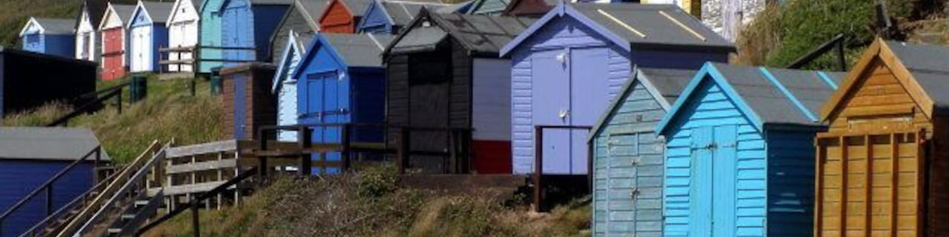 Beach huts, Milford on Sea Beach huts on the cliff at the western end of the beach at Milford on Sea. Wooden steps lead up to the path and car park at the cliff-top.
