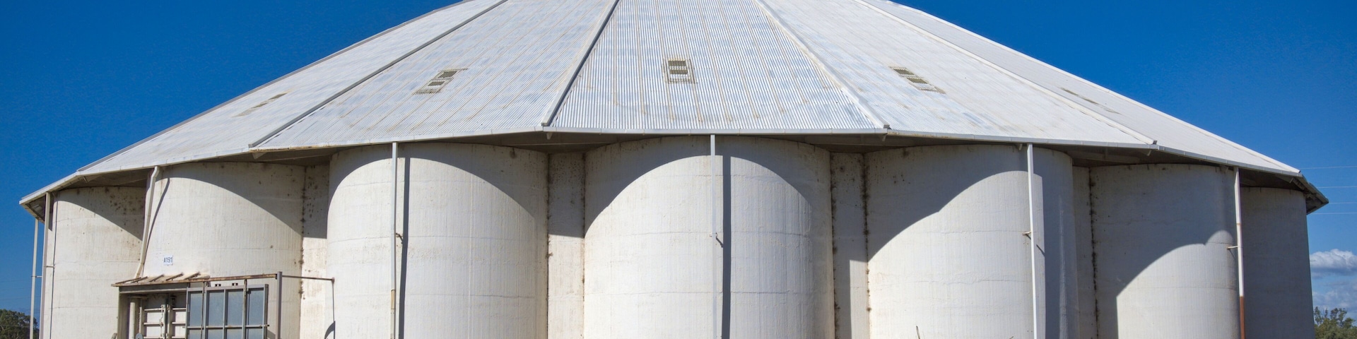 Group of White Grain Silos in a Small Country Town