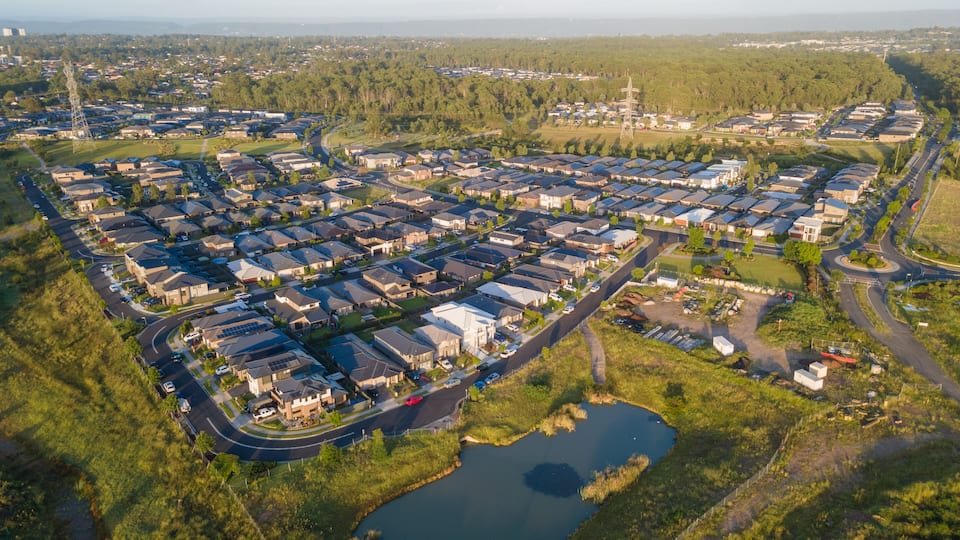 Aerial drone view of Jordan Springs East, known as the sinking suburb, in western Sydney, NSW Australia on a sunny morning in February 2024