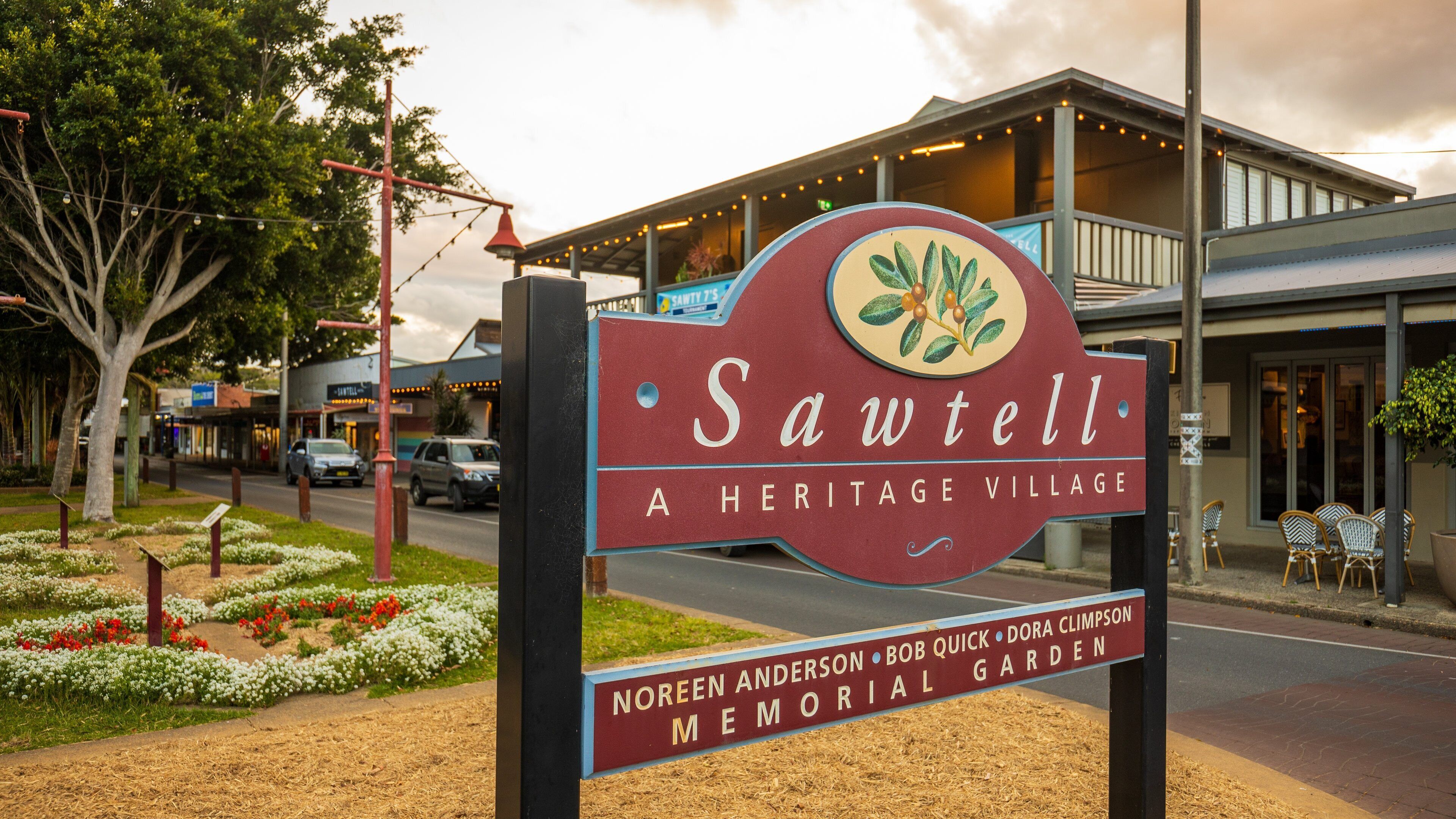 Sawtell which includes signage and a small town or village