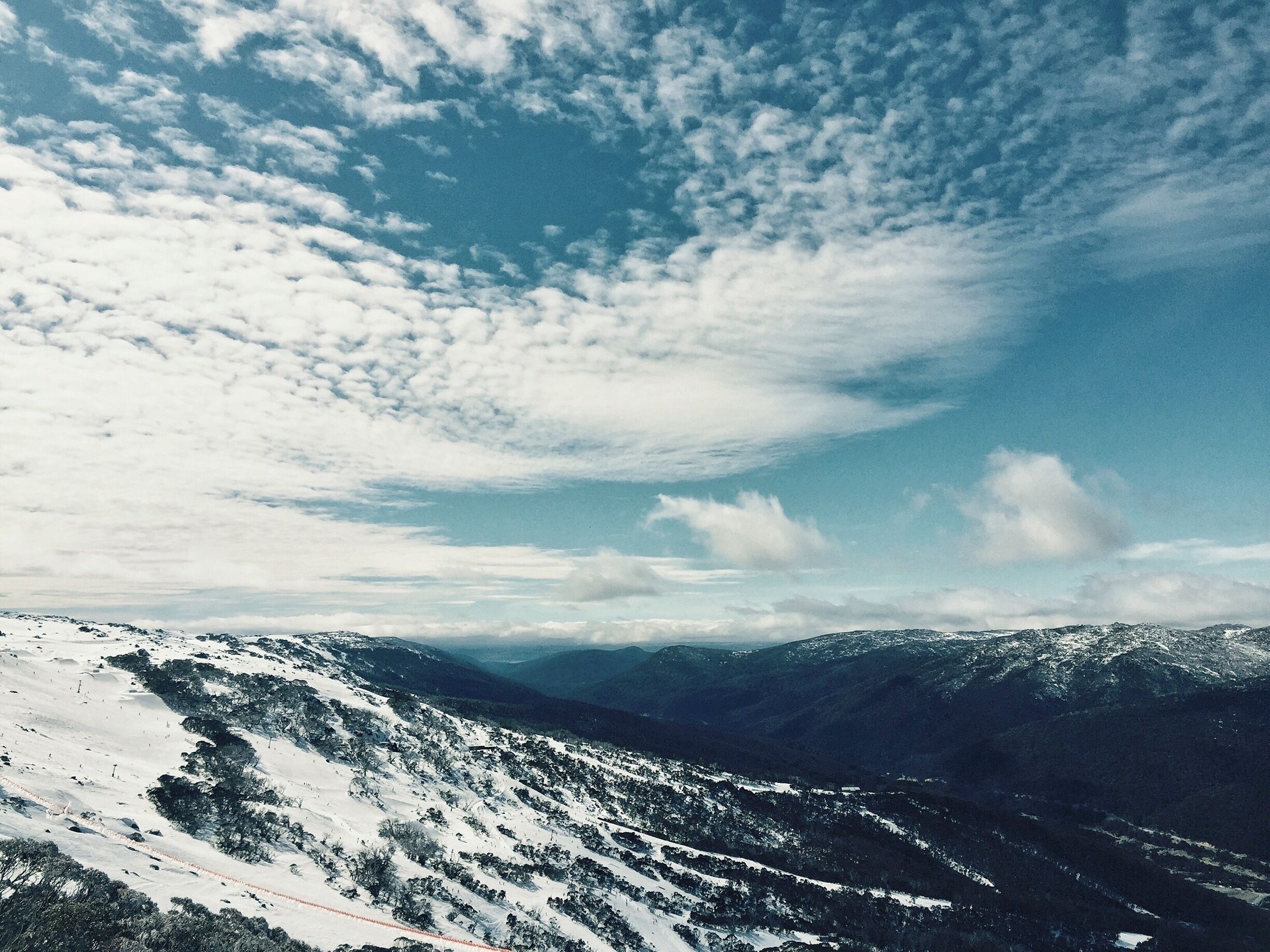 A snow-covered mountain range with a clear sky.