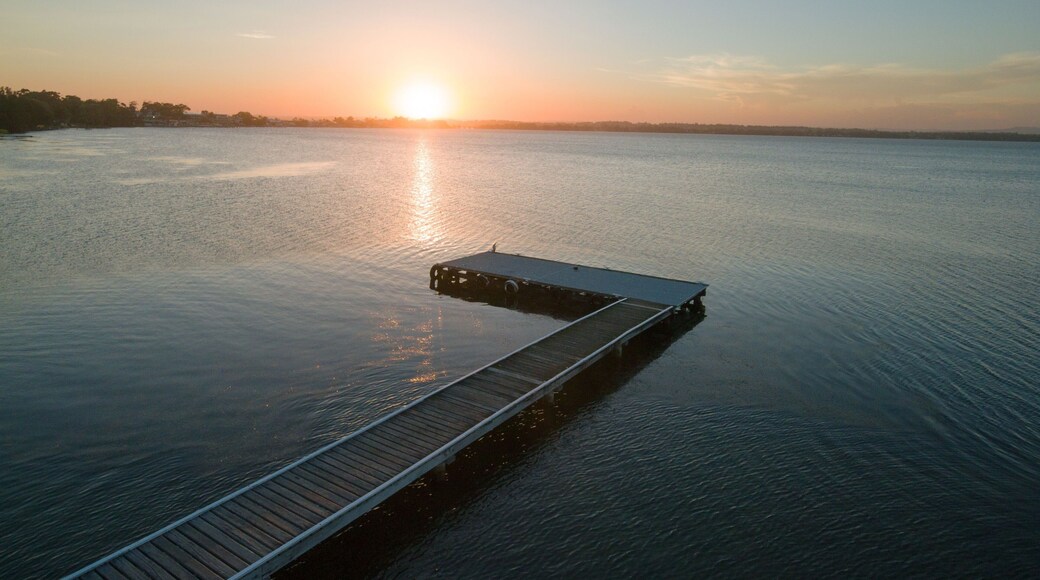 Aerial view of a wooden dock on Toukley lake at sunset in Australia