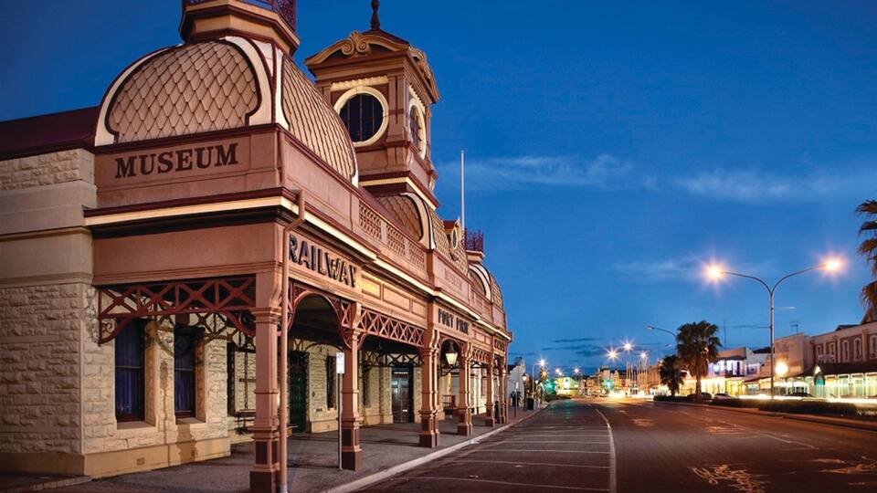 A historic building with a 'Museum' sign, a 'Railway' sign, and a 'Fort Point' sign.
