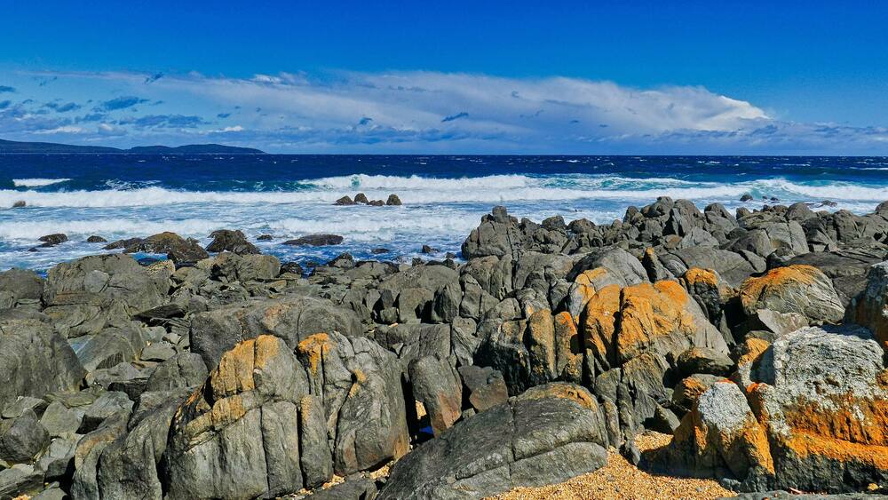 Panorama of a rugged rocky coast and breaking waves on a stormy day. Low Head, George Town, in the Launceston region of northern Tasmania, Australia.