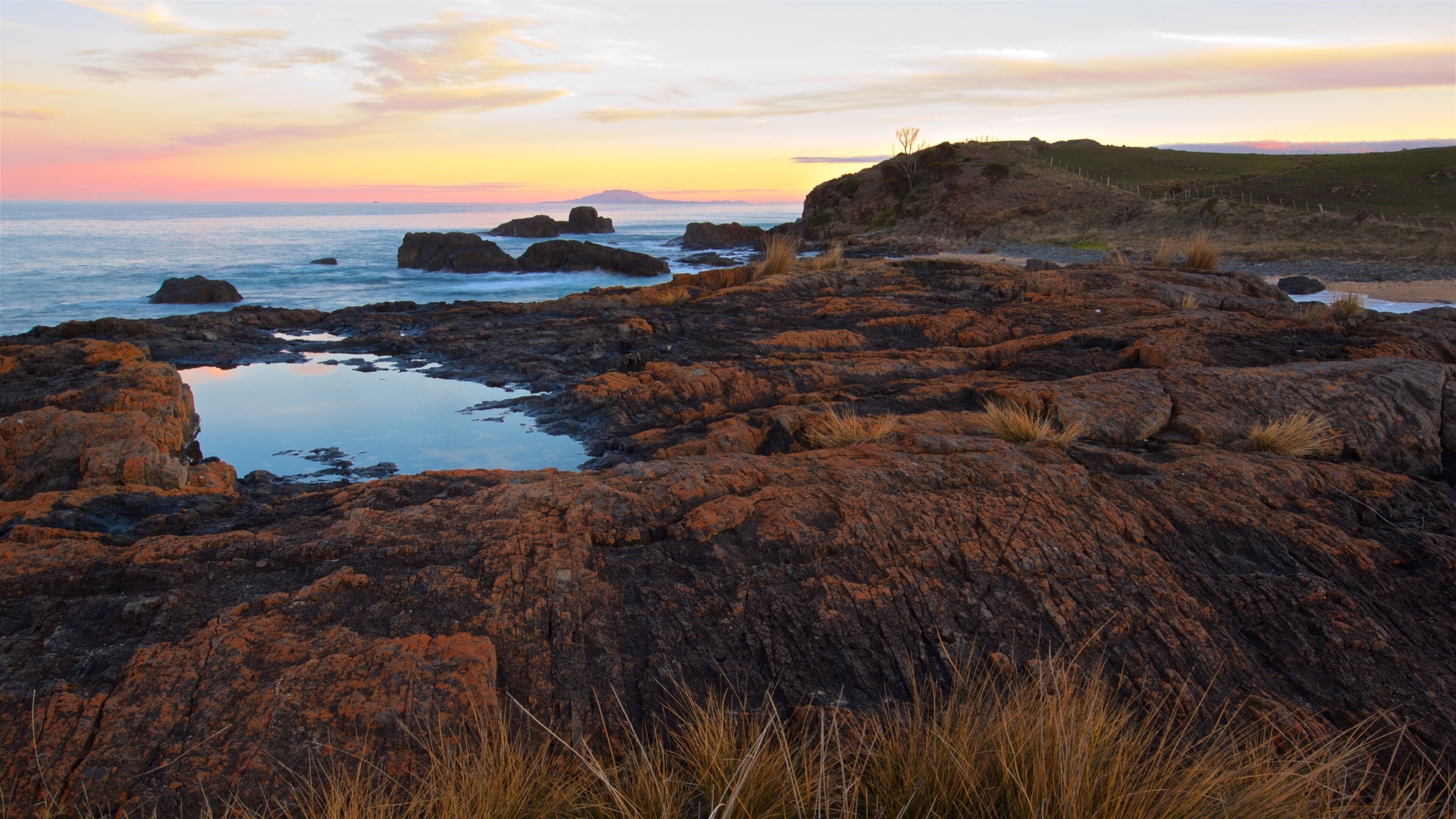 Swansea showing rocky coastline, general coastal views and a sunset