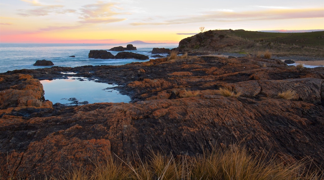 Swansea showing rocky coastline, general coastal views and a sunset
