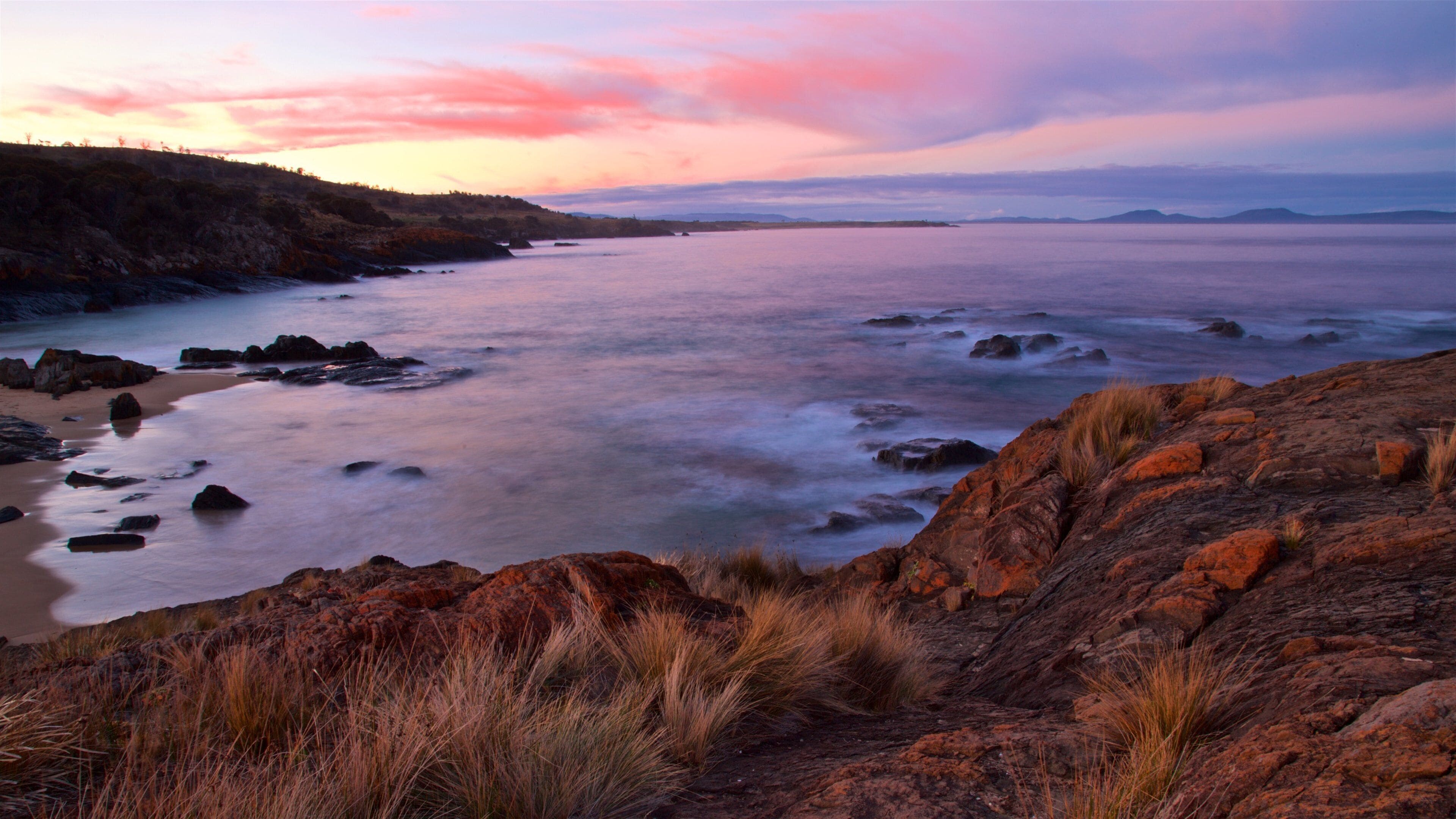 Swansea which includes rugged coastline, general coastal views and a sunset