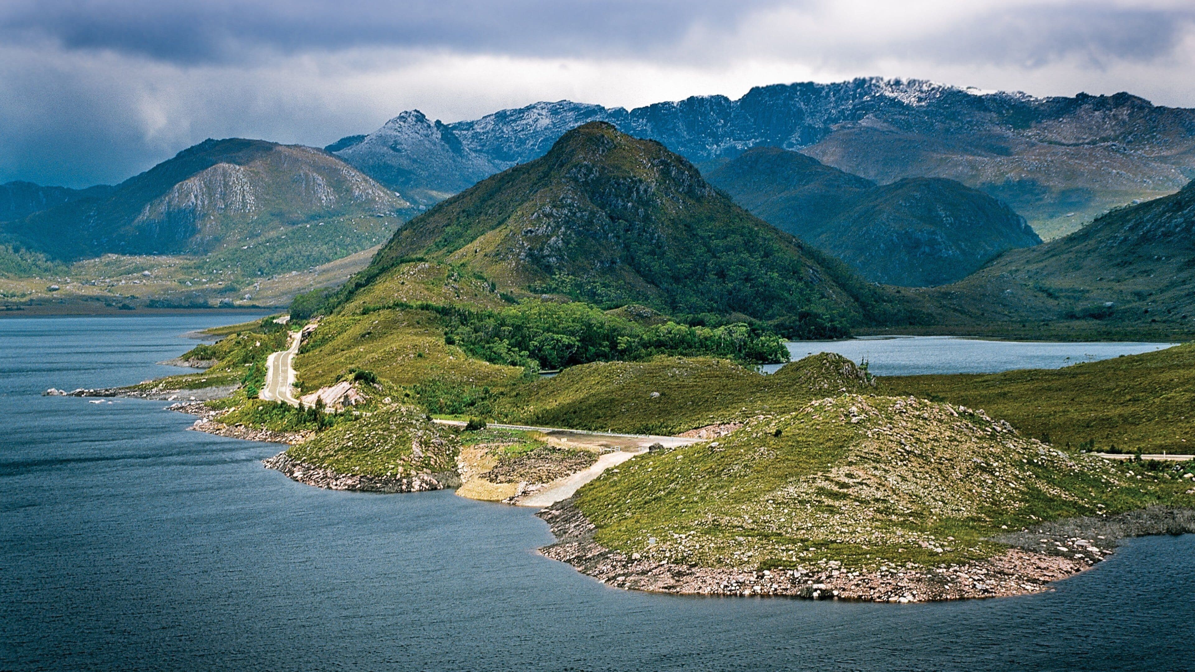 Zeehan which includes a lake or waterhole and mountains