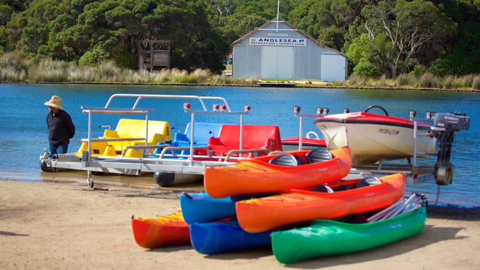 A beach with colorful kayaks and a boat docked near a building labeled "Anglesea Recreation & Sports Club."