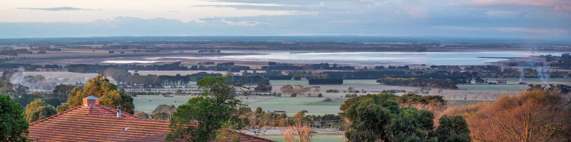 Rooftop sunset - high angle view of farm land by the lake, at sunset, in a small rural town, Camperdown, Victoria, Australia