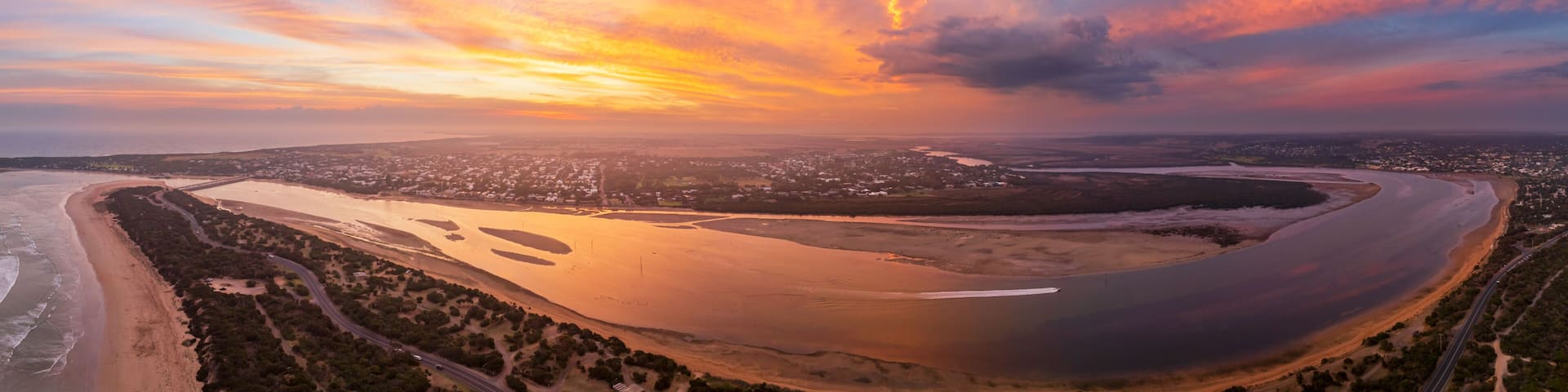 Colorful sunset over coastal river mouth