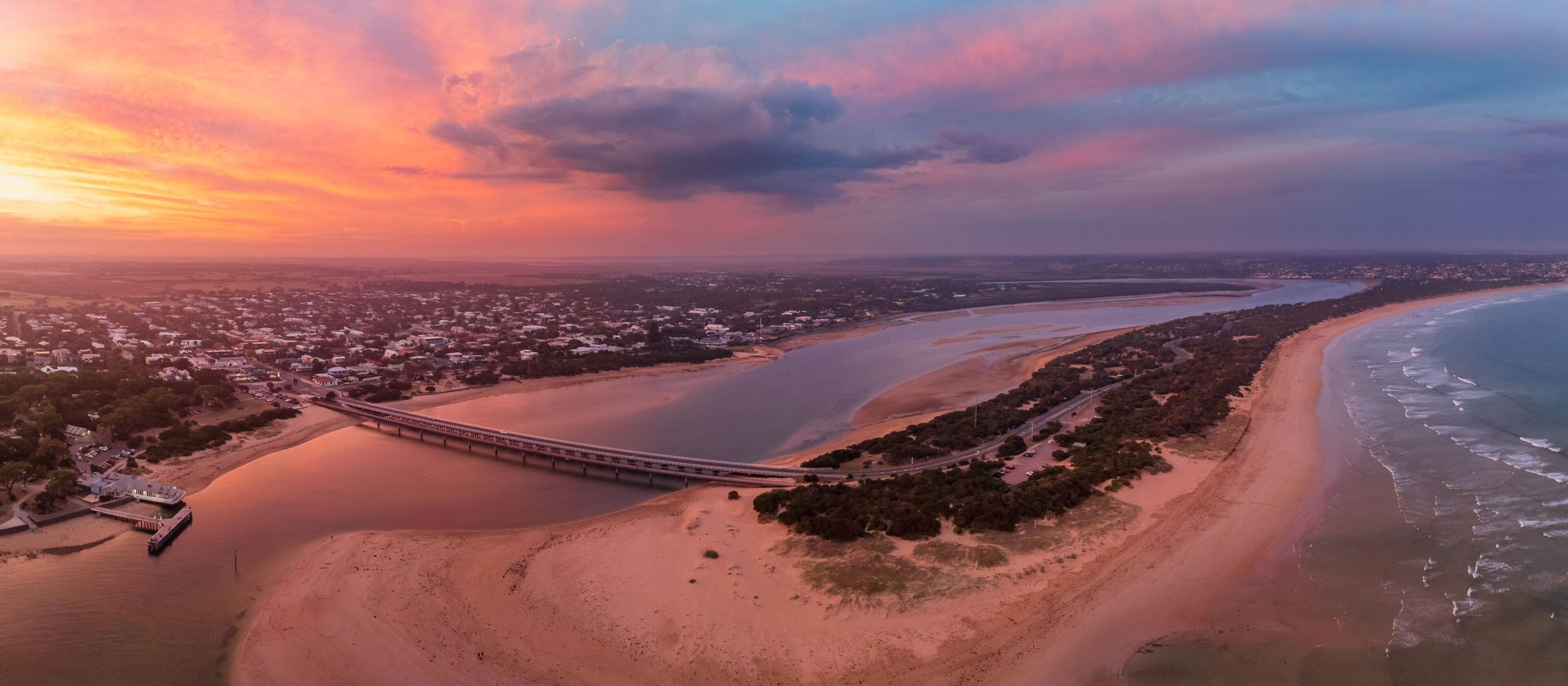 Colorful sunset over coastal river mouth
