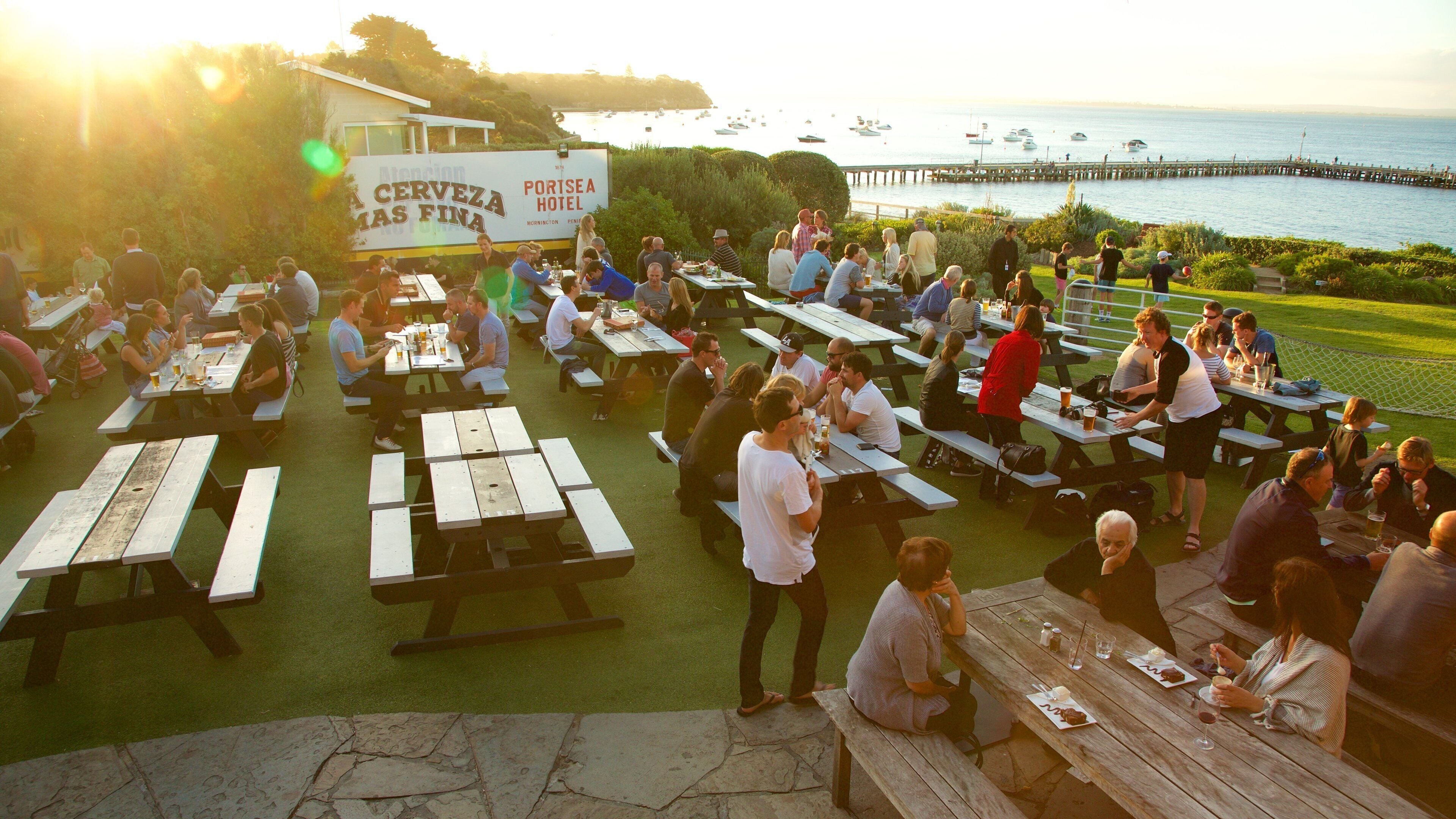Portsea which includes outdoor eating and a sunset as well as a large group of people