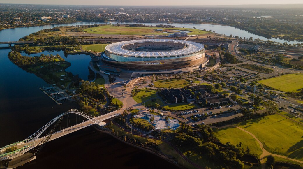 An aerial view of Optus Stadium surrounded by water and greenery.