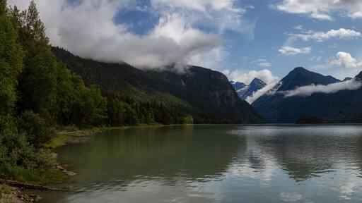 Beautiful Panoramic View of Mud Lake with Mountains in the background. Taken in Blue River, North of Kamloops, British Columbia, Canada.